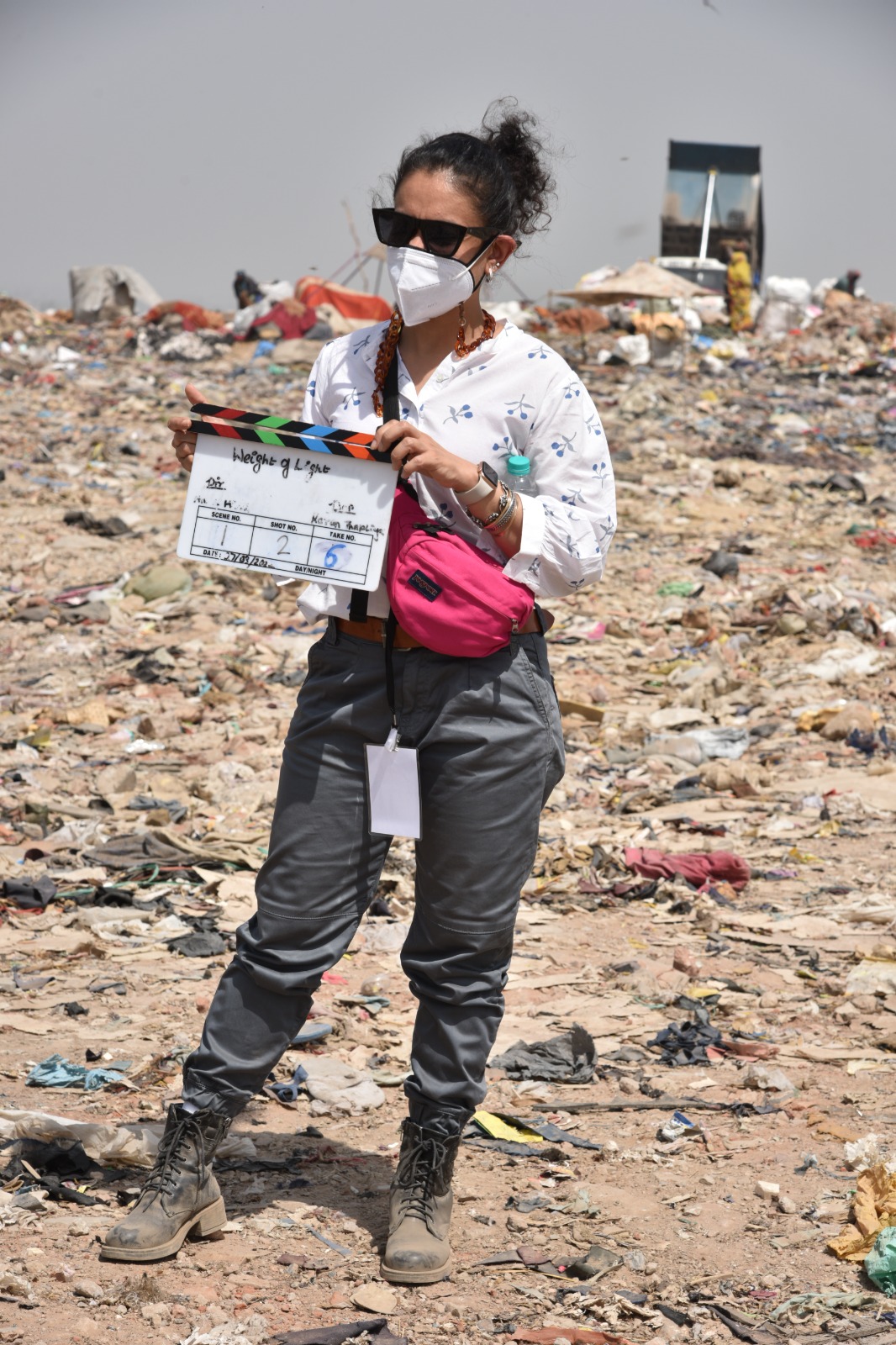 Tanvi Gandhi with a film slate on the set of The Weight of Light